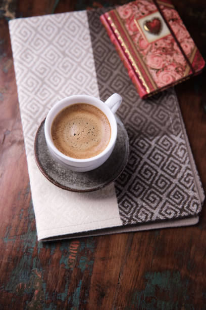 Woman picking up cup with freshly made cappuccino, light effect, copy space