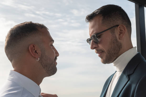 istock Two gay men on their wedding day, close to each other 2197034762