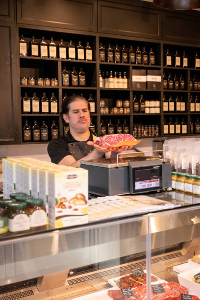istock Butcher weighs meat in shop 2197035236