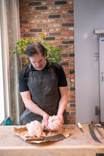 Butcher holds free-range chicken pieces