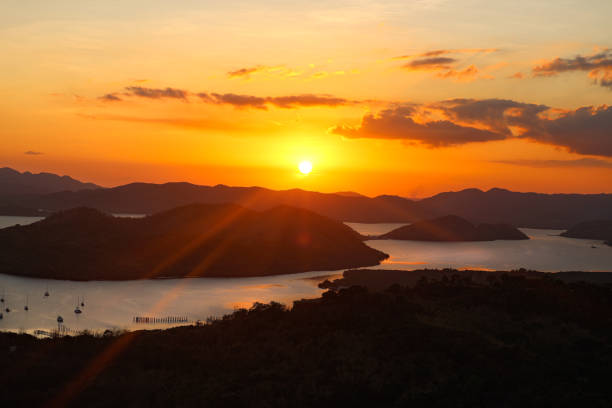istock Sunset in the over the water and mountains 2197039513