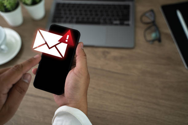 istock men using smartphones warning alert, email hack SMS spam, fake text message phishing 2197039549