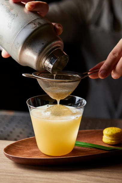 istock A person is making a drink with a shaker and a strainer 2197040234