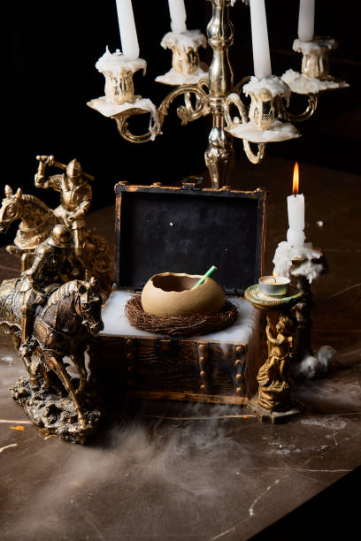 istock A table with a few items on it, including a small box, a cup, and a candle 2197040458