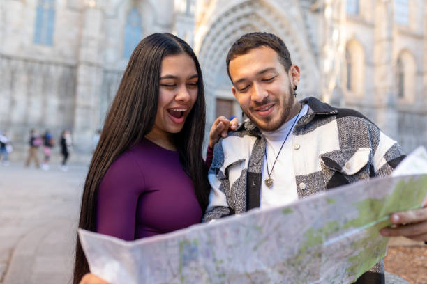 istock Happy tourists couple looking at map while visiting Barcelona, Spain 2197041371