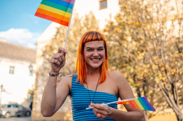 istock Happy activist waving rainbow flags at pride parade celebrating lgbtq plus rights 2197042424
