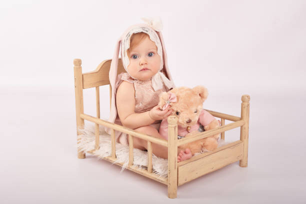 istock Cute funny baby with bunny ear. Easter greeting card, copyspace for your text. Easter bunny. Congratulations on Mother's Day. Easter rabbit. Cute baby girl. Children Protection Day 2197043269