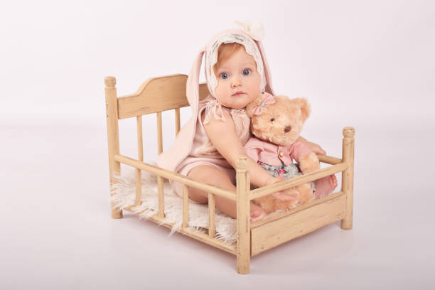 istock Cute funny baby with bunny ear. Easter greeting card, copyspace for your text. Easter bunny. Congratulations on Mother's Day. Easter rabbit. Cute baby girl. Children Protection Day 2197043310
