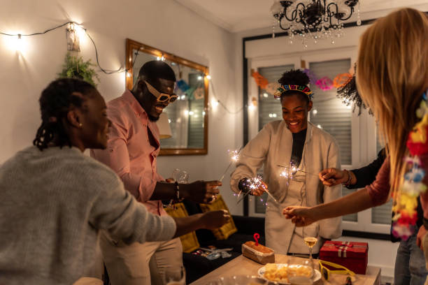 istock Friends celebrating birthday with sparklers and cake 2197044257