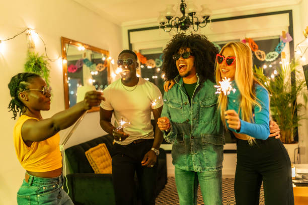 istock Friends celebrating with sparklers at home party 2197044311