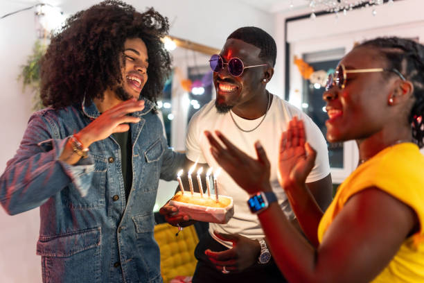 istock Friends singing happy birthday and clapping hands at party 2197044390