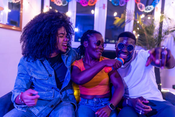 istock Friends singing karaoke at home party with neon lights 2197044403