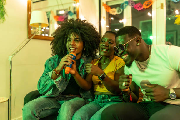 istock Friends singing karaoke at home party 2197044405