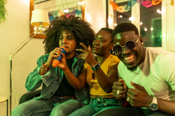 istock Friends singing karaoke at home party 2197044408
