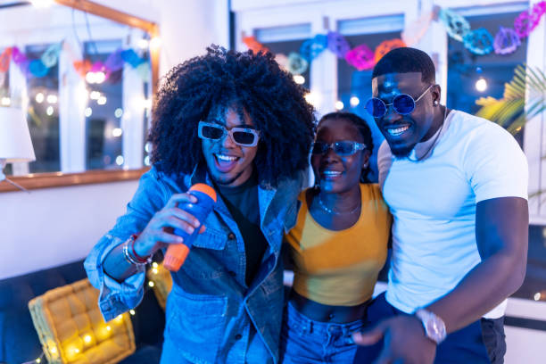 istock Friends singing karaoke at home party 2197044417