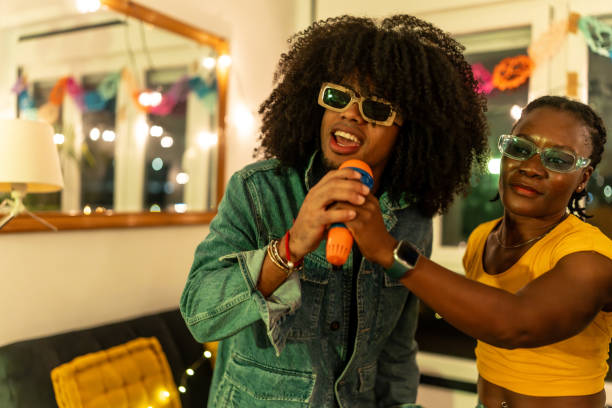 istock Two young adults singing karaoke at home party 2197044419