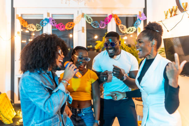 istock Friends singing karaoke at home party 2197044423