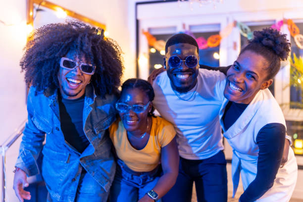 Four friends smiling and having fun at home party