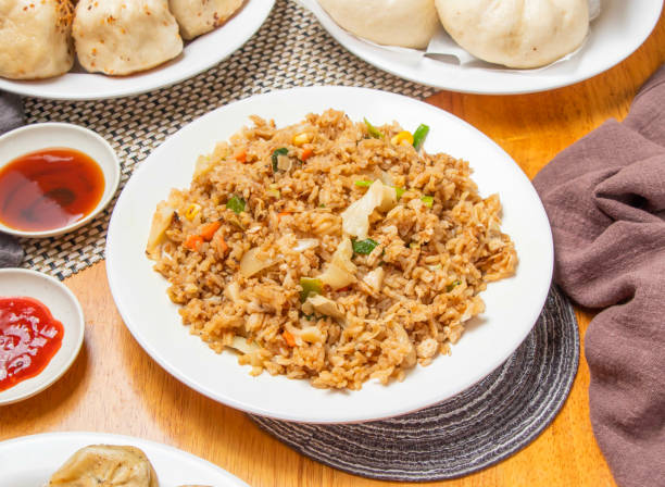 istock Egg Fried Rice with Steamed Buns and Dipping Sauce served in plate isolated napkin side view of chinese dim sum food 2197045792