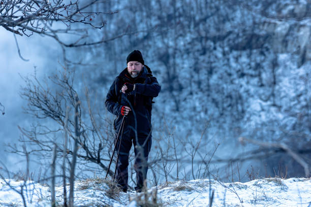 istock Winter hiker using trekking poles in snow-covered mountain terrain 2197046530