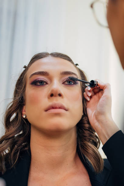 istock Make-up artist applies mascara to her client's eyelashes in a make-up studio 2197046654