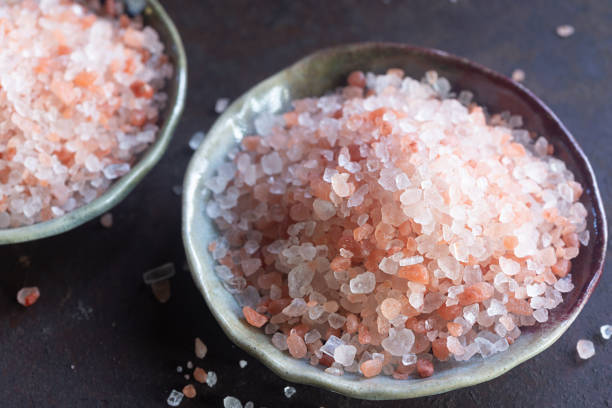 istock Himalayan pink salt in ceramic plate on rusty table background. 2197047164