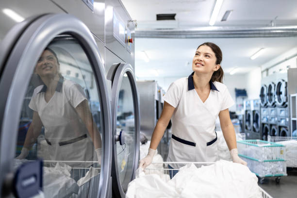 istock Professional cleaner working in dry cleaning service. 2197052828