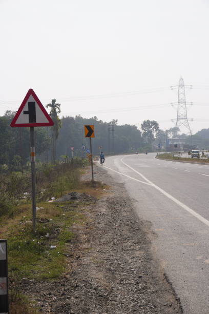 istock Right turn sign and left side road sign board in the roadside 2197055254