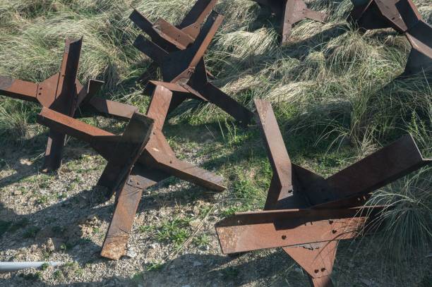 istock World War II anti-tank obstacles on the grass at Normandy beach 2197055541