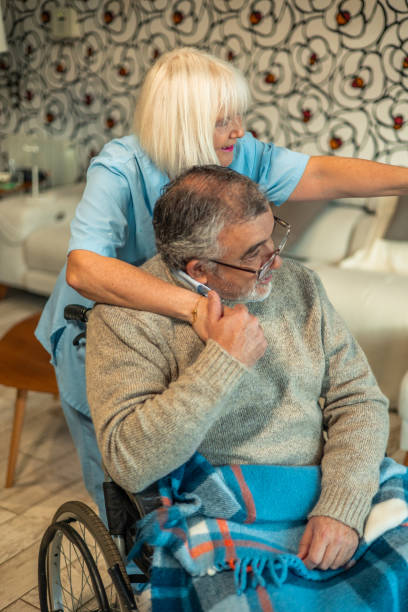 istock Nurse caring for elderly man in wheelchair, pointing to something 2197056519