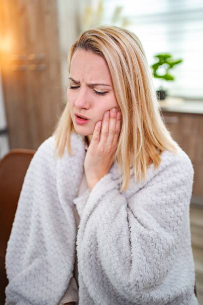 istock Young Woman Suffering From Toothache at Home 2197057445
