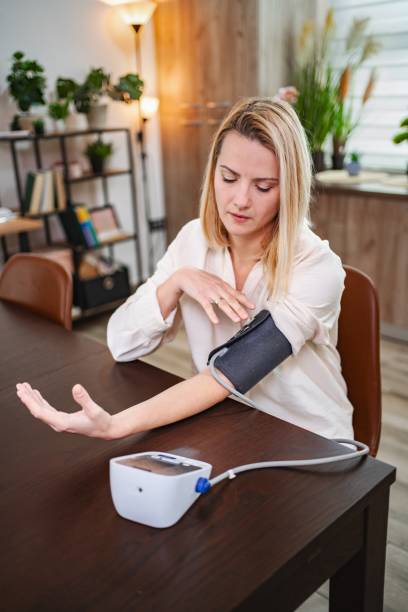 istock Woman measuring blood pressure at home using a digital blood pressure monitor 2197057504