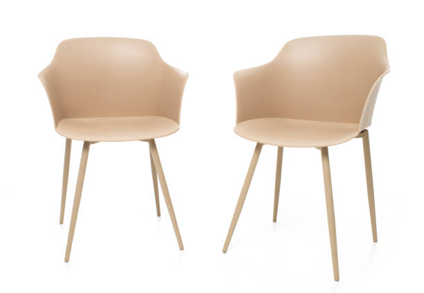 istock Two modern beige plastic chairs with metal legs isolated on a white background. 2197057522