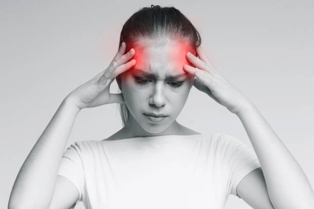 istock Woman suffering from headache, touching her temples 2197058269
