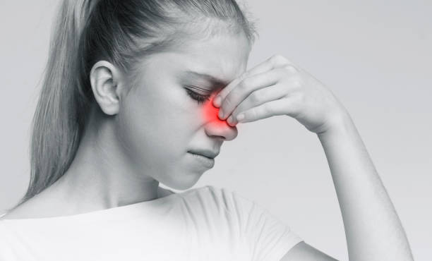 istock Sad woman holding her nose because sinus pain 2197058310