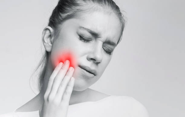 istock Young woman suffering from strong tooth ache 2197058313