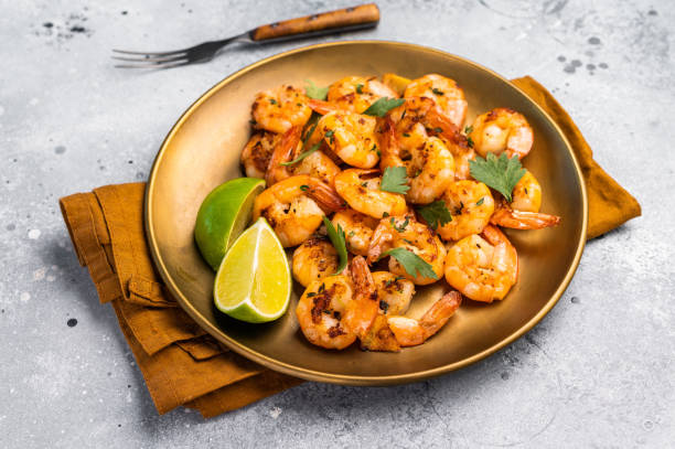 istock BBQ dinner with roast Shrimps Prawns in a plate. Gray background. Top view 2197058775