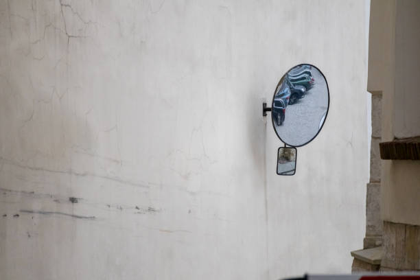 istock .a round mirror attached to a dirty white wall. 2197062396