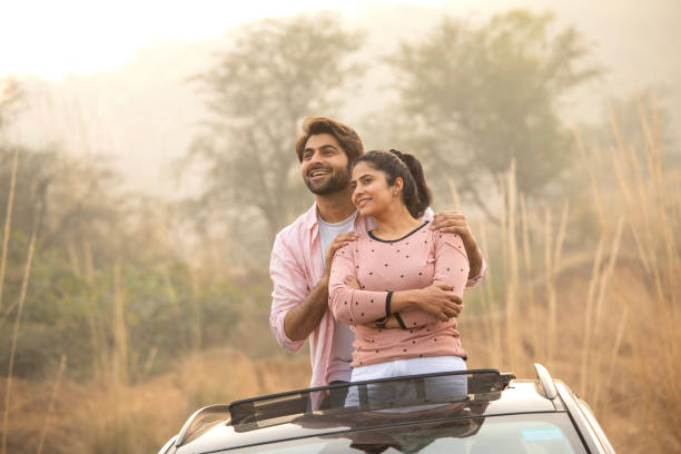 istock Carefree couple looking away through car sun roof 2197063361
