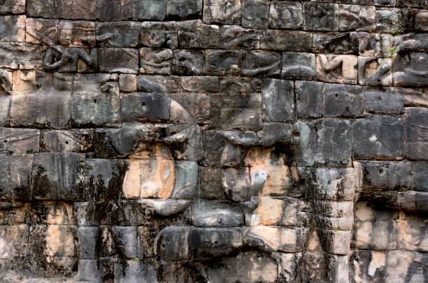 Shot in color detail on the facade of this historic building representing some character, animal or flower. Set at Siem Riep, Angkor Wat , Cambodia, Asia