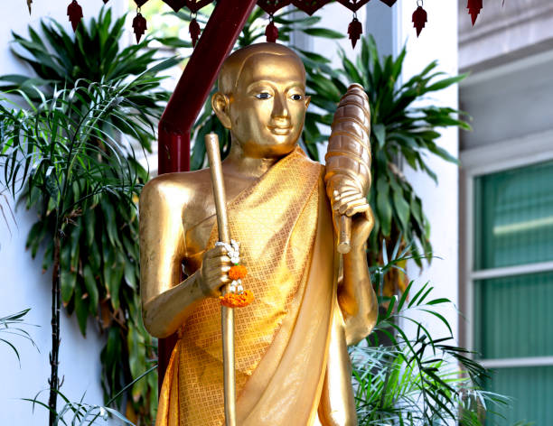 Shot in color detail on the facade of this historic building representing some character, animal or flower. Inside a buddhist temple in the city of bangkok.Set at Bangkok, Thailand, Asia