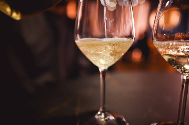 istock Poring white wine into glass 2197070648
