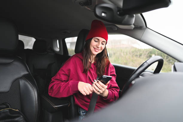 istock Woman text messaging in car. 2197070850