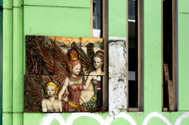 Shot in color detail on the facade of this historic building representing some character, animal or flower. Set at Bangkok, Thailand, Asia