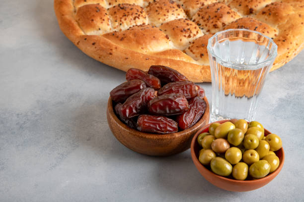 istock Dates fruit, green olives, Ramadan pita, and water for the iftar table 2197071902