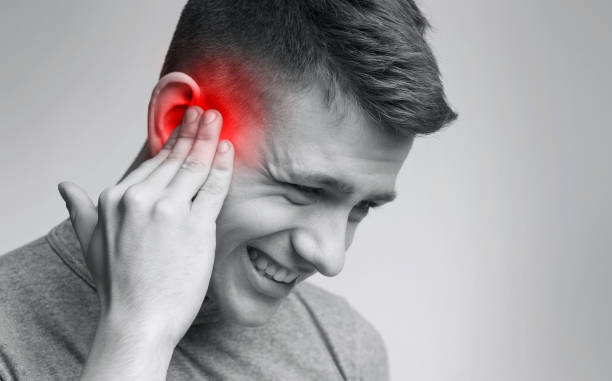 istock Young man suffering from acute pain in ear 2197078676