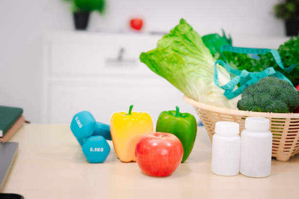 istock A nutritionist's table with a vegetable basket, fruits, pill bottles, and a dumbbell, symbolizing health, balanced nutrition, fitness, supplements, and a commitment to a healthy lifestyle 2197079089