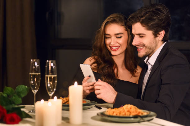 istock Lovely young couple looking at smart phone 2197080886
