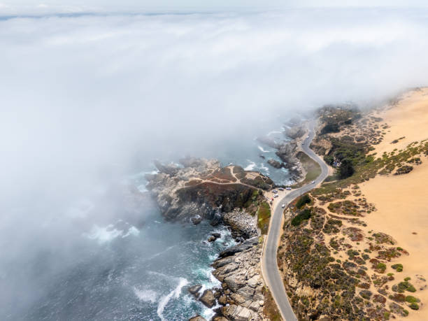 istock Coastal Highway Overlooking Rocky Shoreline and Misty Ocean 2197081670