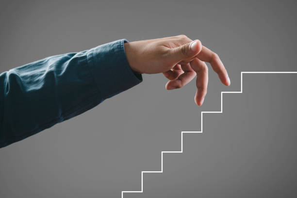 istock A close-up image of a hand reaching towards a staircase, symbolizing progress and ambition in personal growth. 2197083840